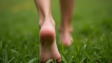 Woman walking barefoot on grass