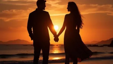 Couple holding hands at sunset